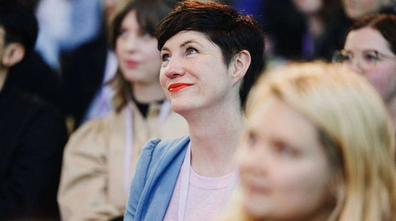 A photograph of an attendee in the audience at DO Conference